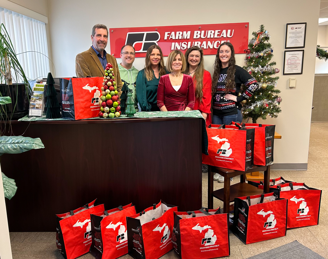 Group standing in front of bags of food