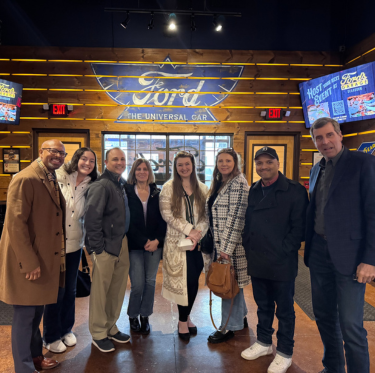 Group of people standing at Fords Garage